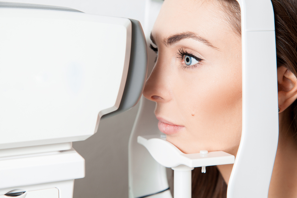 woman receiving an eye exam from her optometrist